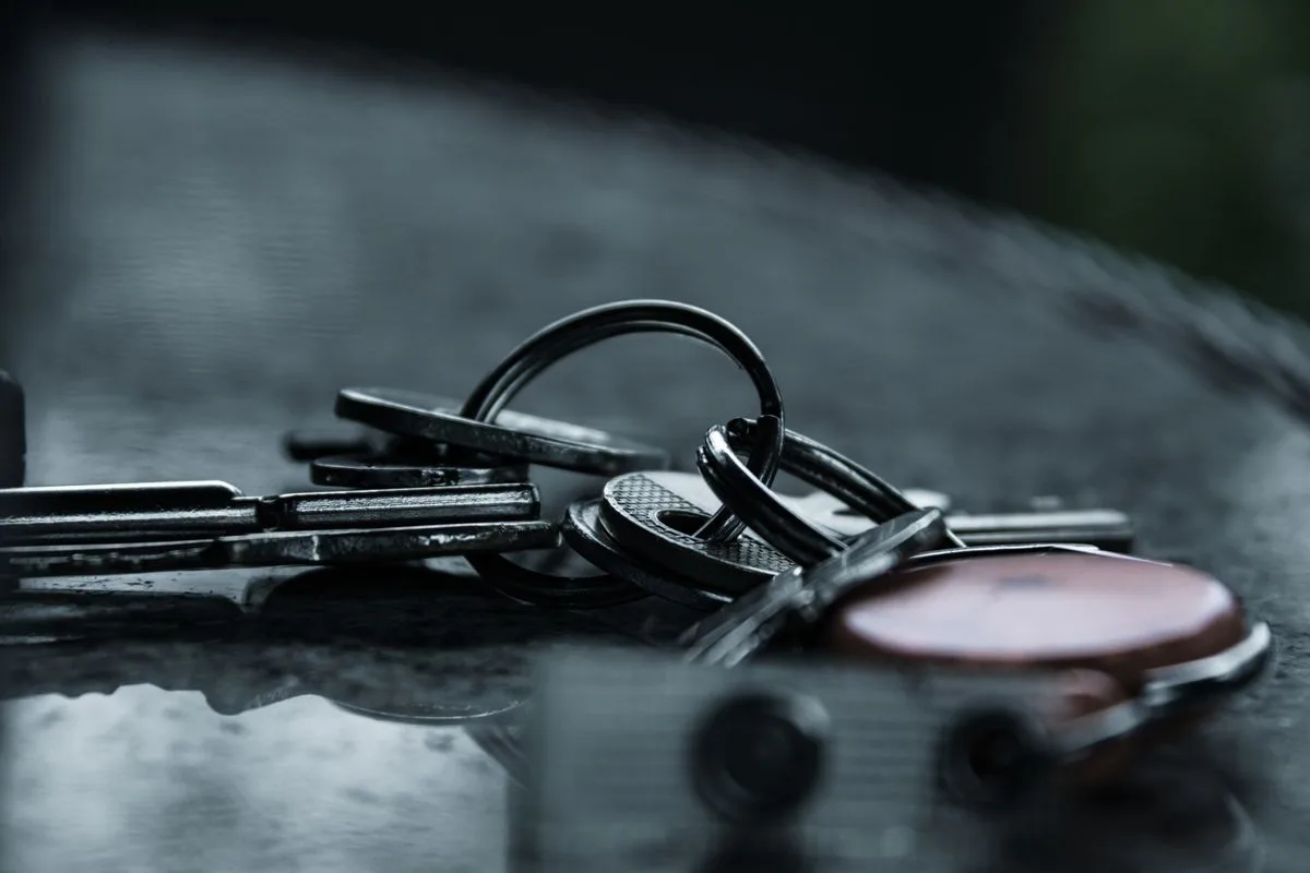 Worn metal keys on a reflective surface