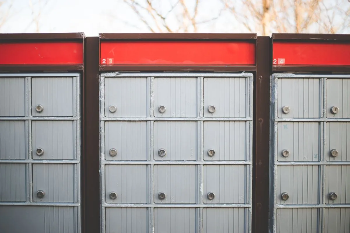 Outdoor community mailbox unit with individual locking compartments