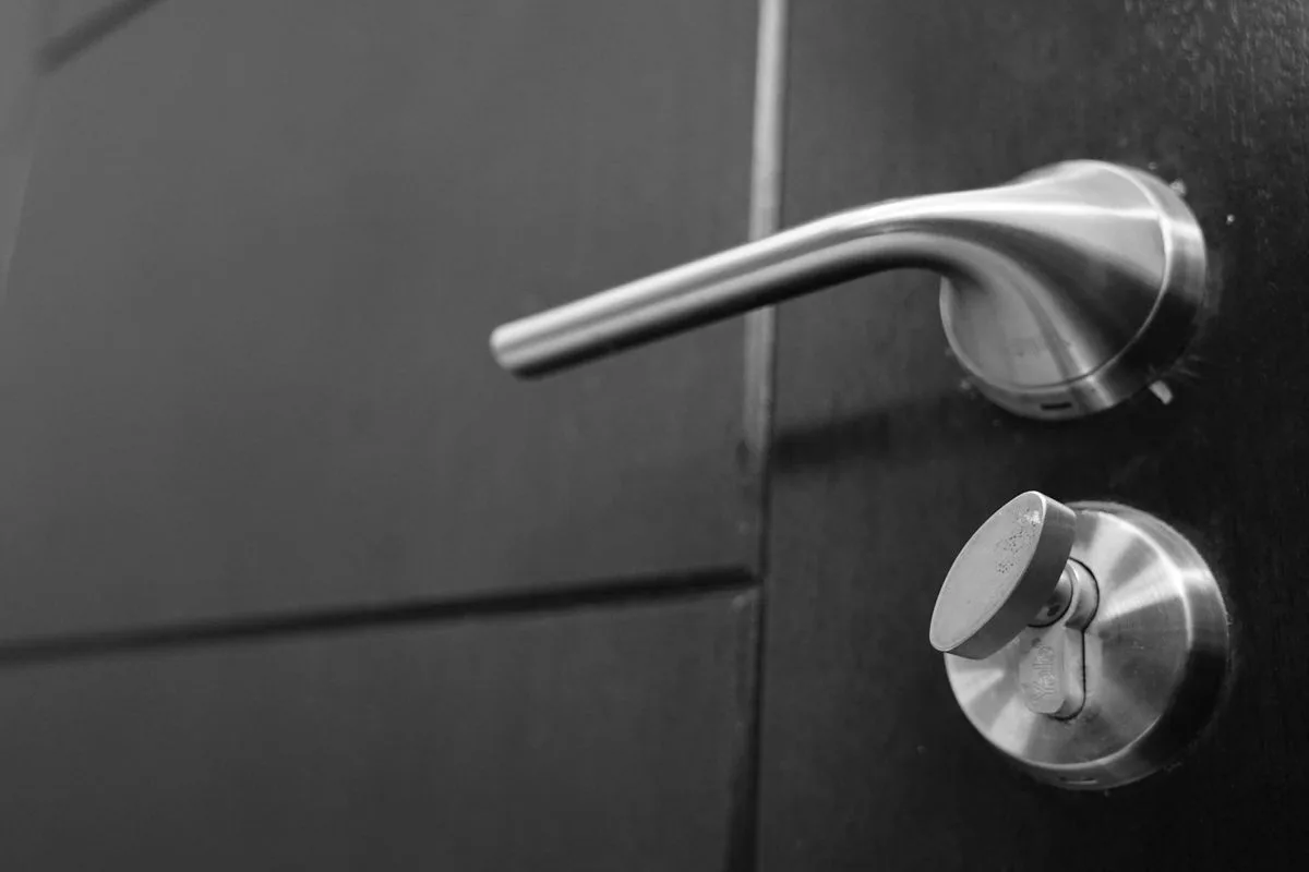 Close-up of a stainless steel commercial door lever and lock